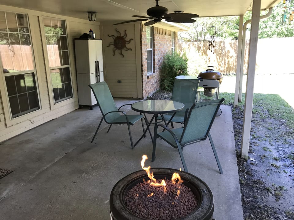 covered patio with fire pit and grill