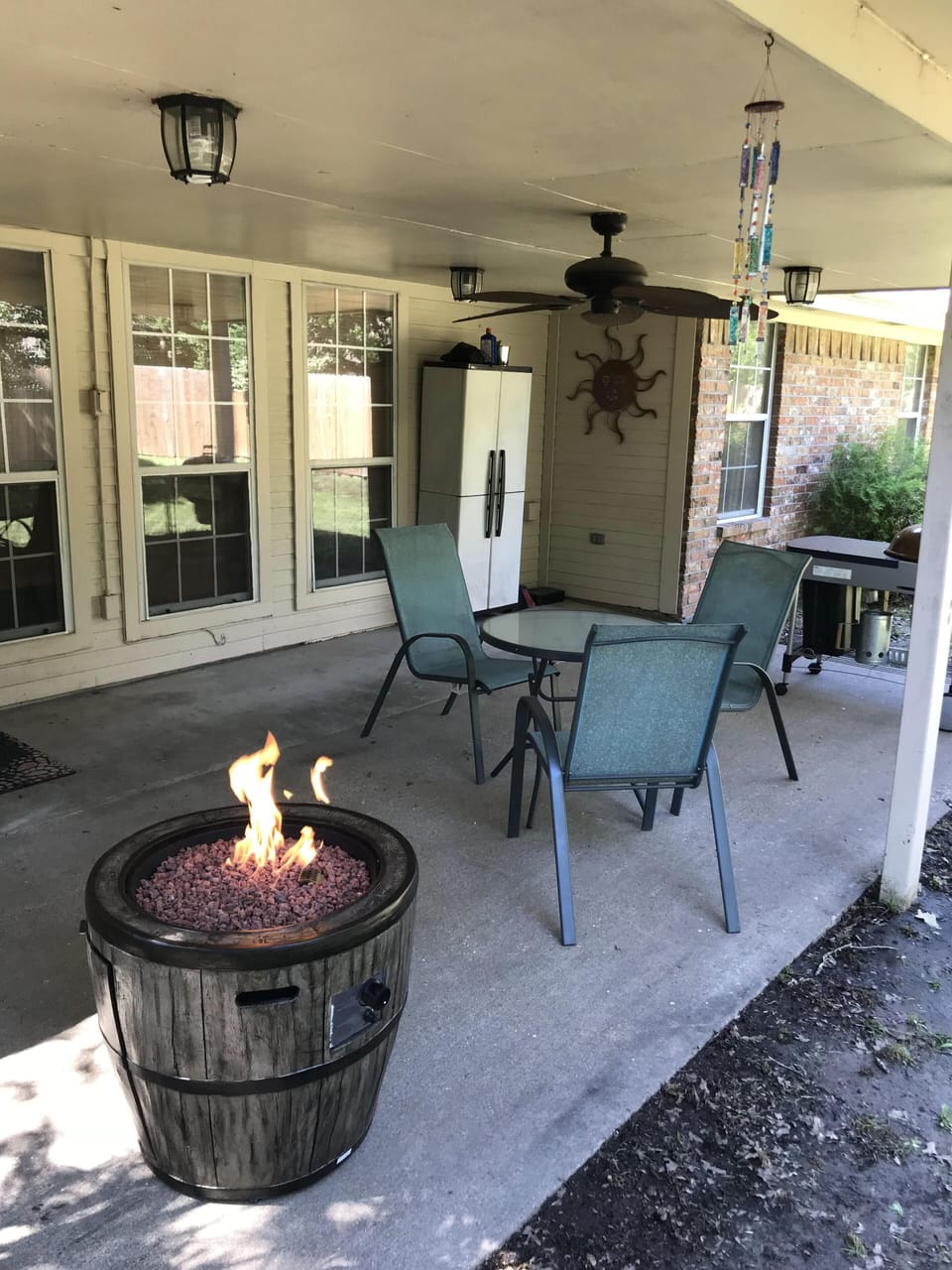 covered patio with fire pit and grill
