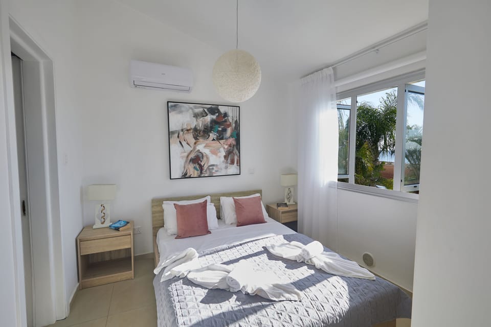 Bedroom 1 with en suite bathroom, double bed and sea views