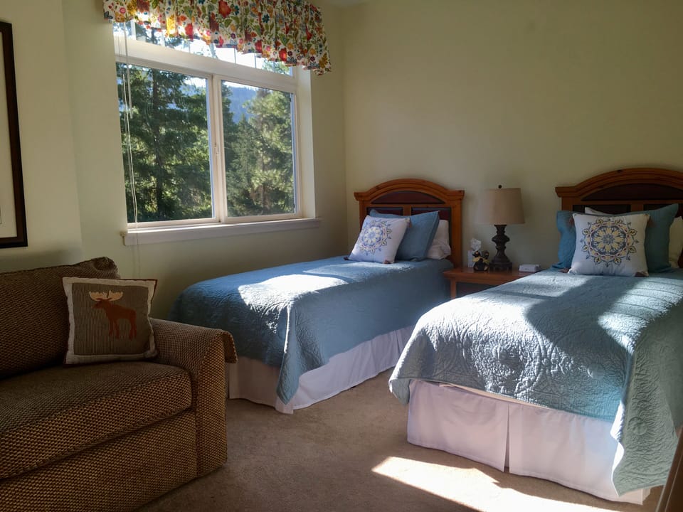 Guest bedroom upstairs with two twin beds.