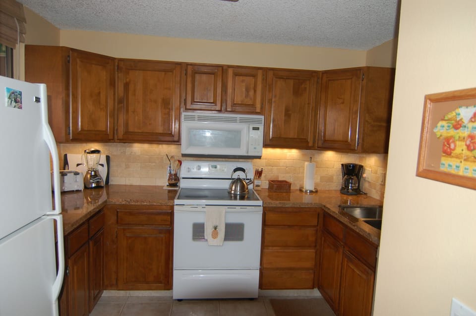 Kitchen with the new granite countertops and under cabinet lighting.
