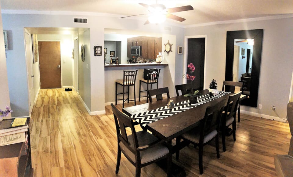 Entrance to condo with kitchen, bar counter and dining area.