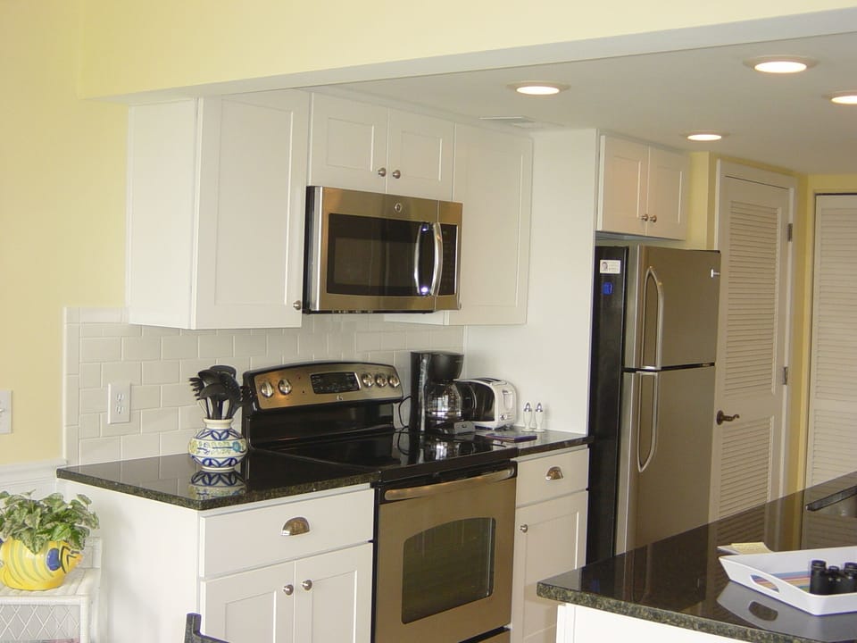 ALL NEW kitchen with stainless steel refrigerator, range, microwave and granite.