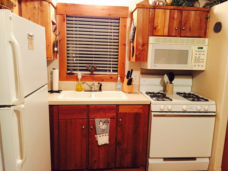 Kitchen w/dishes, pots, pans, utensils, microwave, stove, K cup, toaster. 
