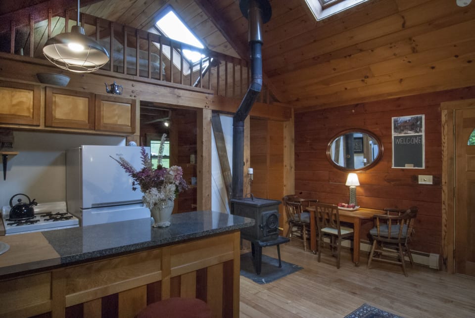 Our dining table seats 4-6 people. Located right next to our woodturning stove.