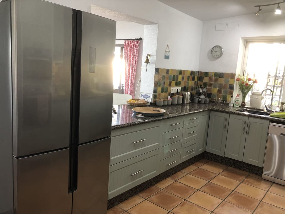 kitchen with serving hatch through to dining area.
