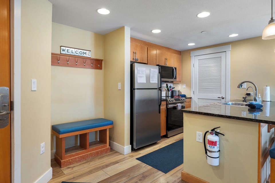 Coat hooks in entry with bench for putting on boots
