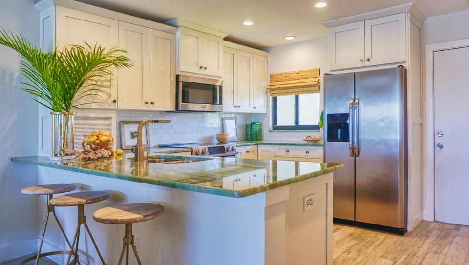 The kitchen is just inside the entry to your right with an open bar and walkway through to the other end of this luxury home. Stainless steel appliances, guest stool seating facing the kitchen, cook ware and all the appliances you need add to the feeling of home.