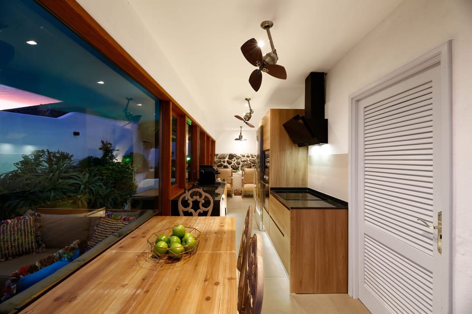 Kitchen at night with flood lit garden 
