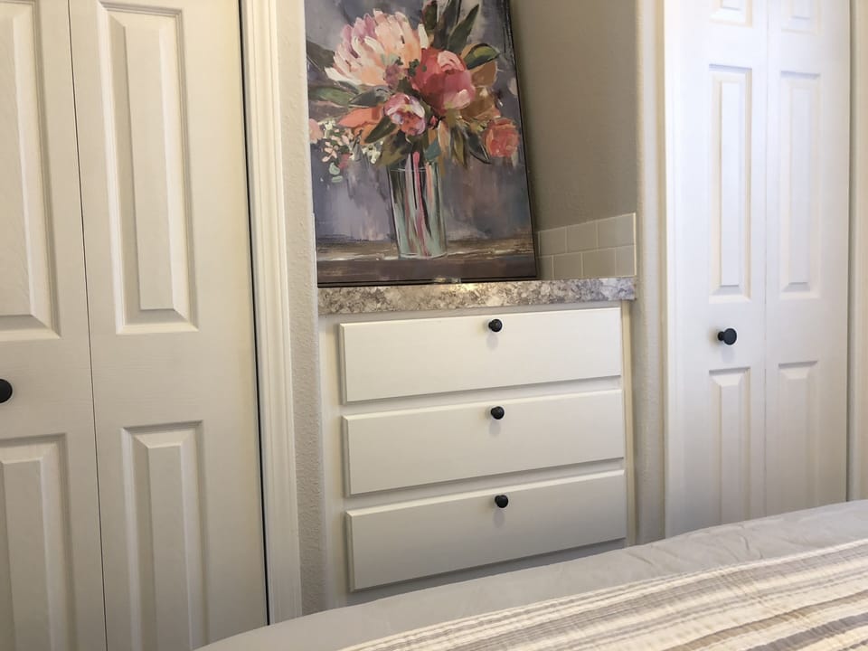 Two closets and a set of drawers in the master bedroom
