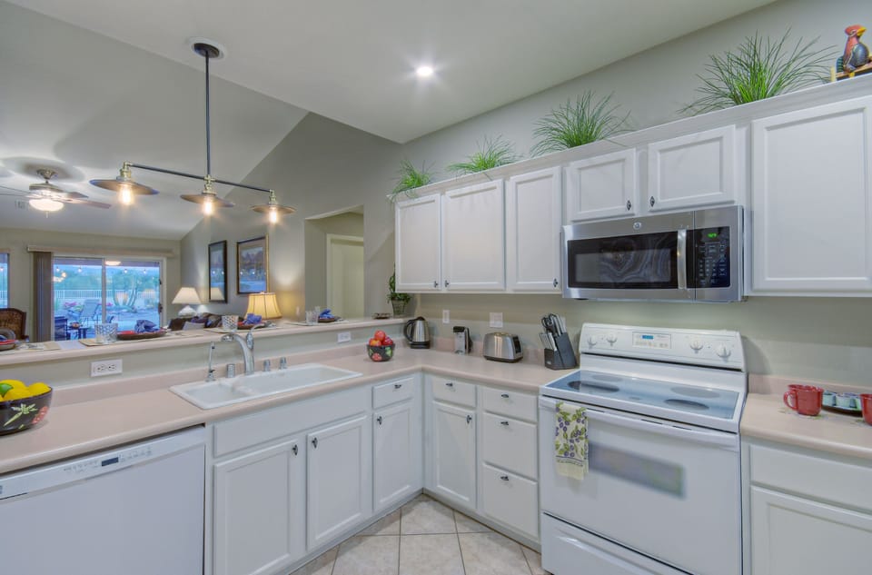 Bright and well stocked kitchen overlooks the backyard.