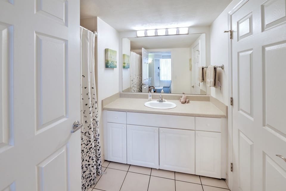 Bathroom with tub shower combination and powder room