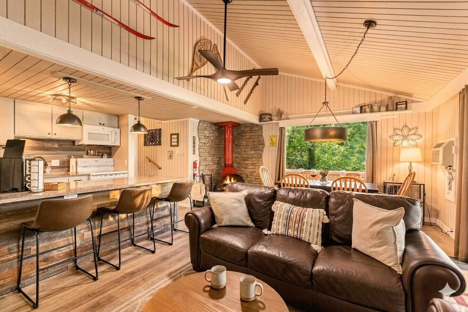 Iconic retro fireplace and open living space — pure Northern Michigan charm