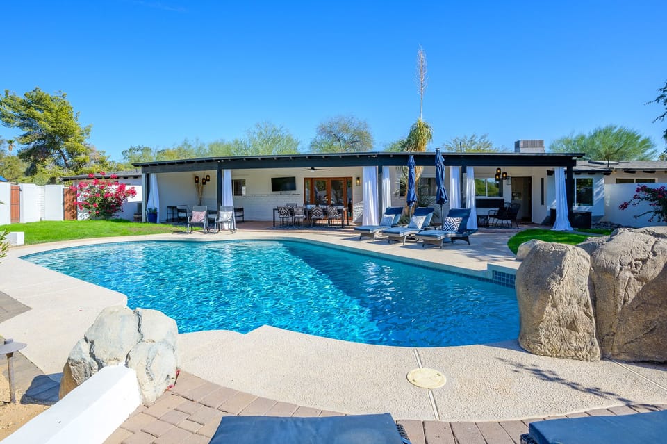 Large covered patio overlooks beautiful pool. Covered and open spaces for all.
