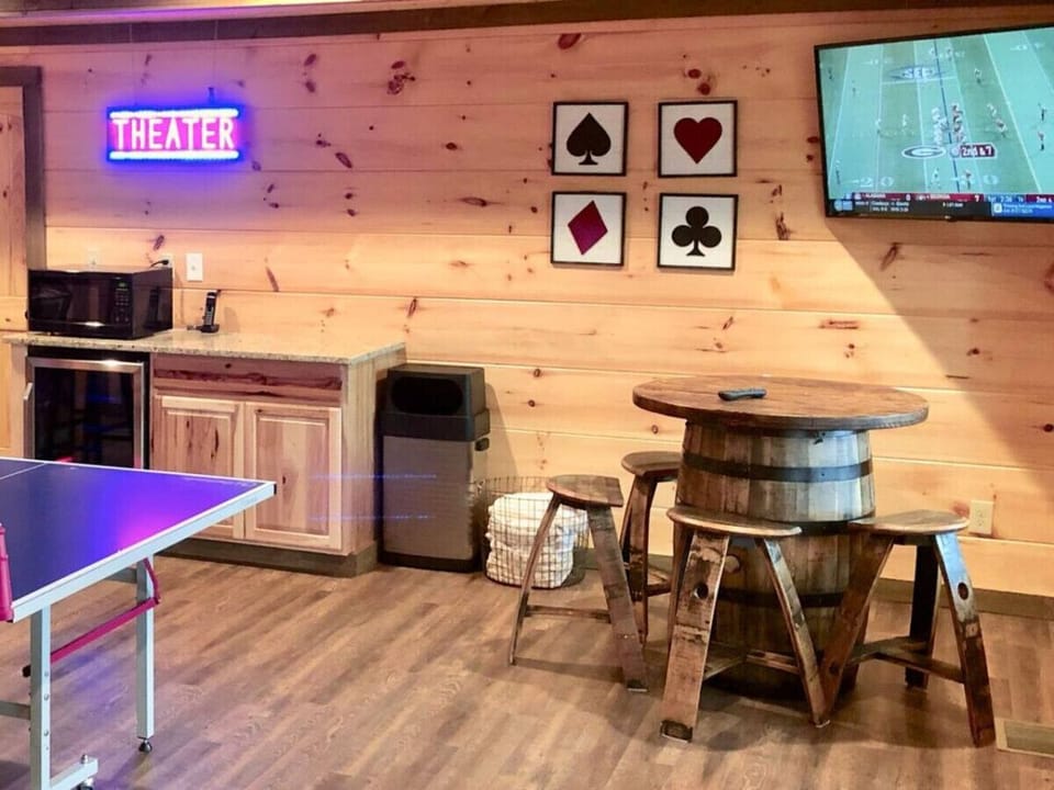 The game room also has a barrel pub table, TV, beverage cooler and microwave.