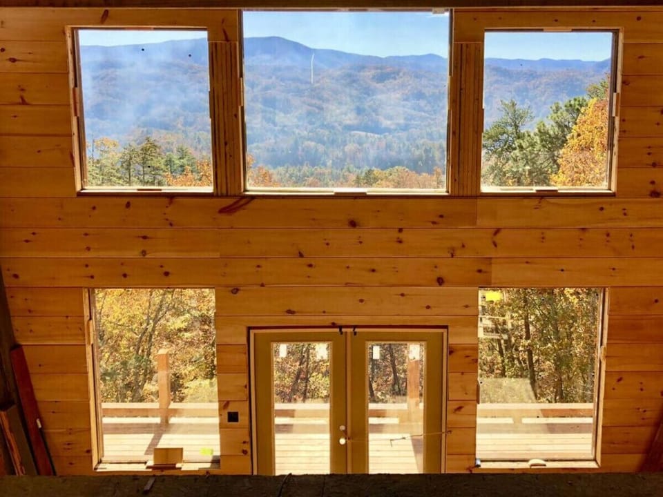 The cabin has a 2 story wall of windows to admire the incredible mountain views.