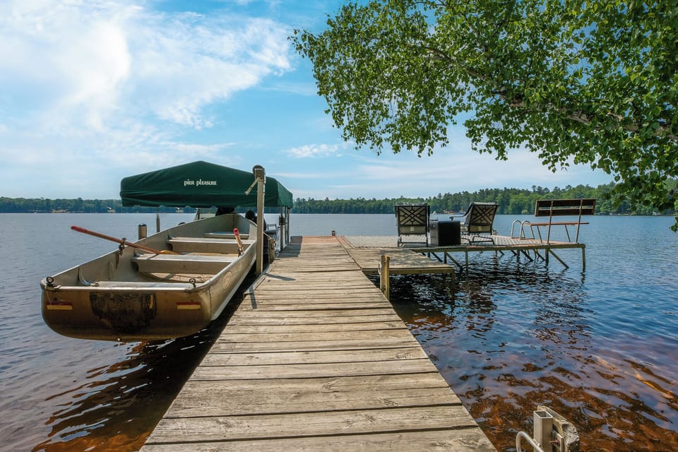 Expanded dock with our rowboat, fishing boat, + lots of room for your boat(s)!