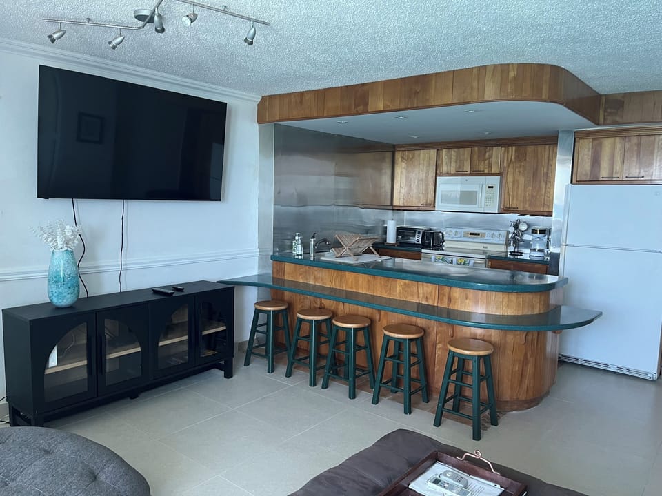 Kitchen with new floor and 65 inch TV