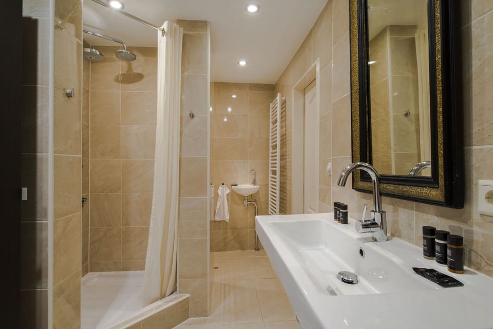 Bathroom including shower and separate bath
