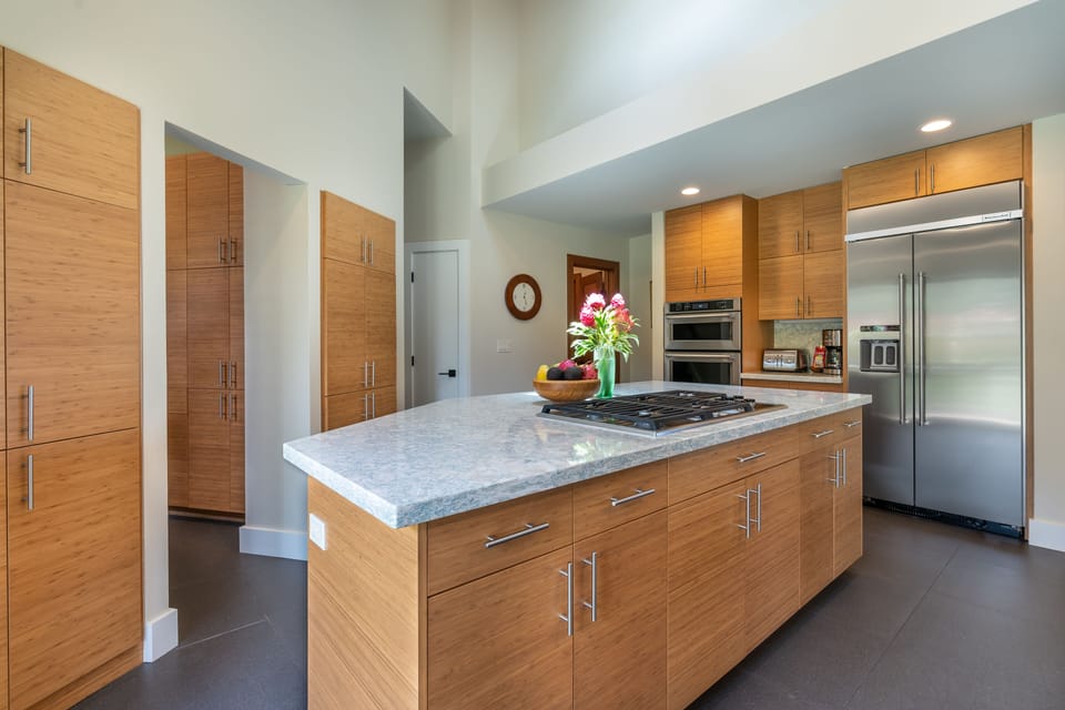 Modern kitchen stocked with high quality cookware. utensils, small appliances.