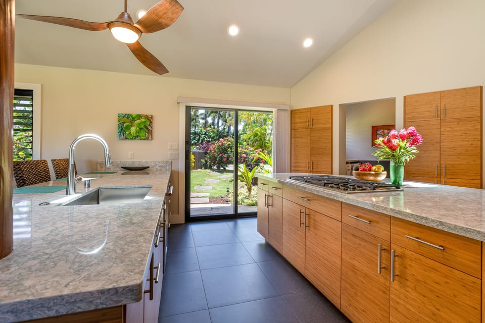 Easy access to Kitchen-Aid stainless grill outside glass sliding doors
