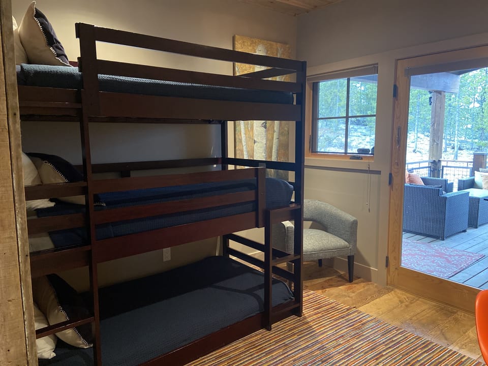 Main floor triple bunk/office room off kitchen with kid lock door to patio.