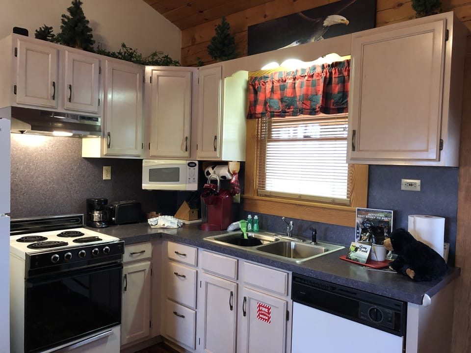 Fully equipped kitchen with all appliances, dishes, pans, silverware