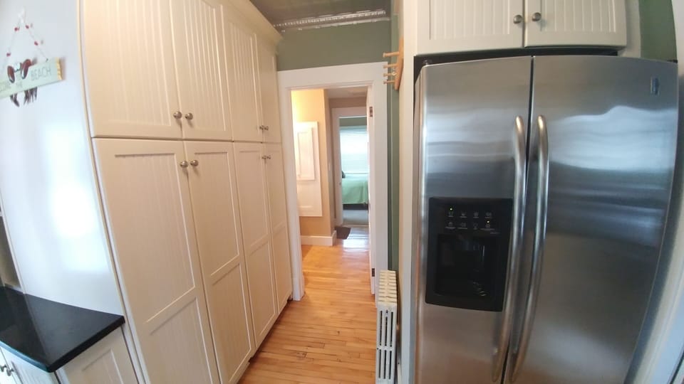 Hallway into bathroom that leads to back bedroom