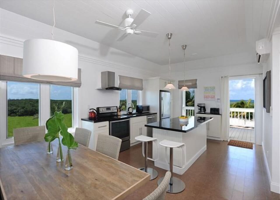 Modern kitchen in black granite and stainless steel, with views of both oceans.