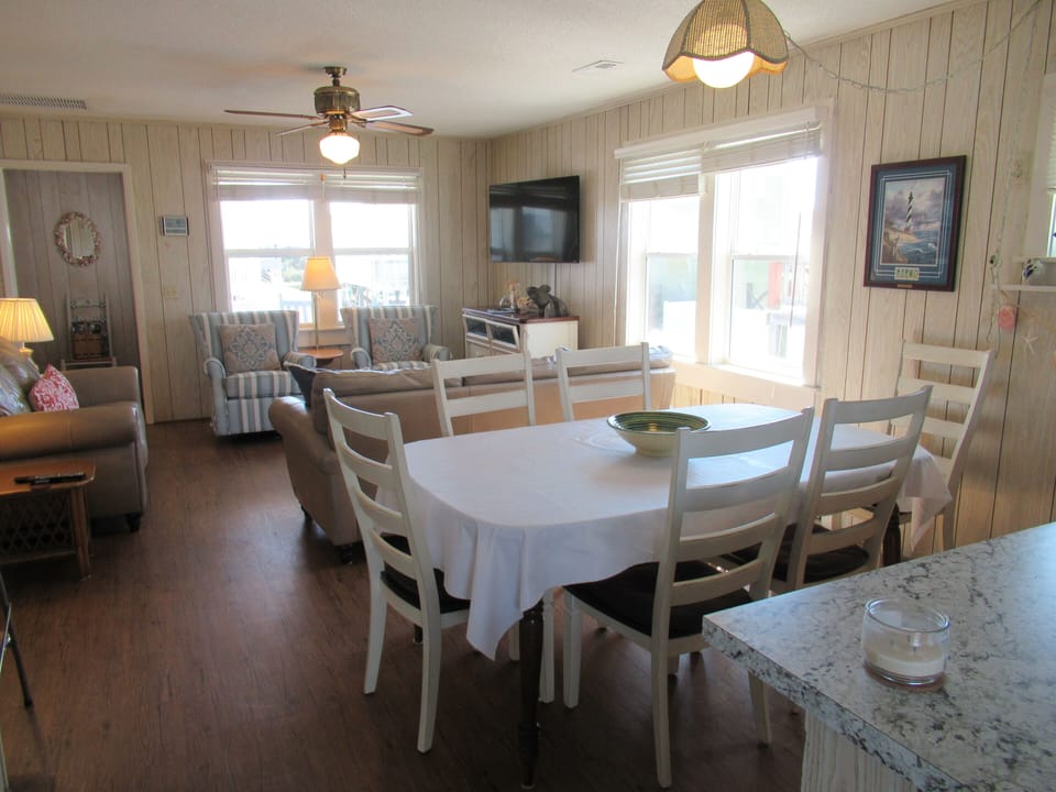 Large living /dining area with 6 seats & 3 bar stools. Sofa, love seat 2 chairs.