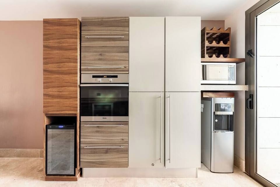 Kitchen Cabinets, Pantry, Water Dispenser, Microwave, and Wine Fridge
