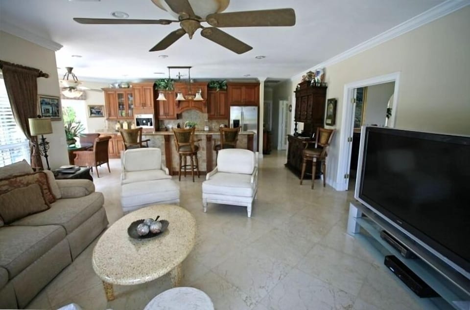 Family room with wide screen tv looking into kitchen area