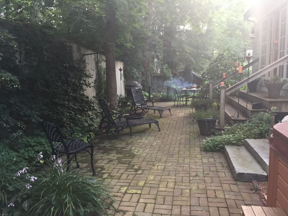 Brick patio with outdoor seating and gas grill.