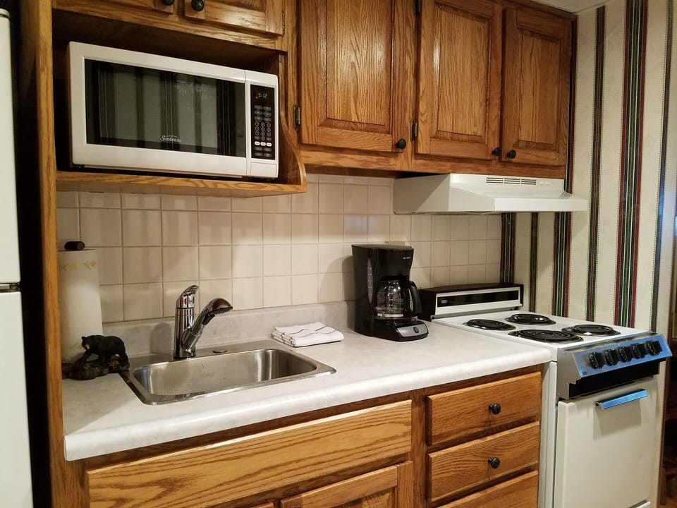 Full kitchen with stove, microwave, coffee maker, etc. 