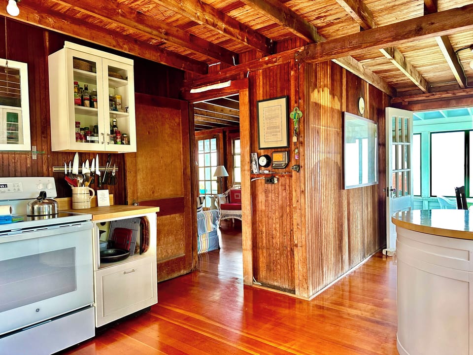 Kitchen view through to the living room on the left and the porch on the right.