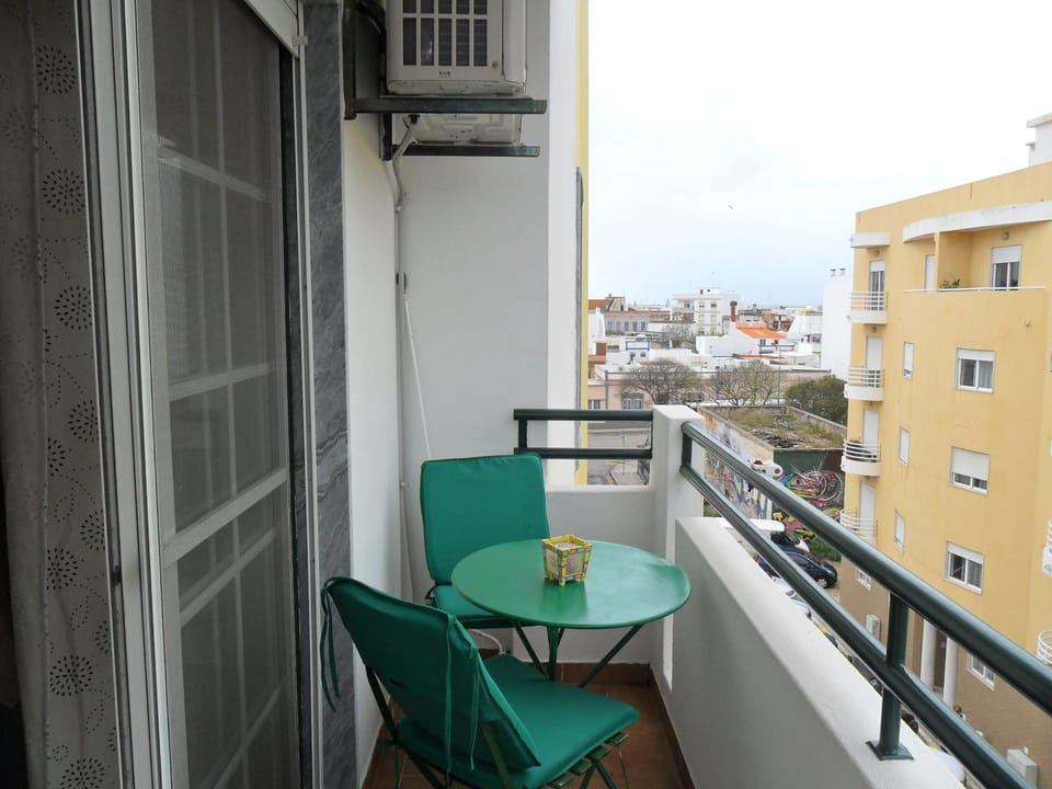 Small balcony overlooking street and train station