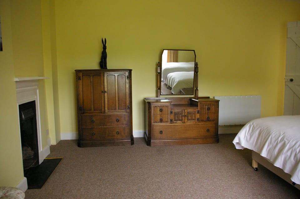 Large bedroom furniture and fireplace.