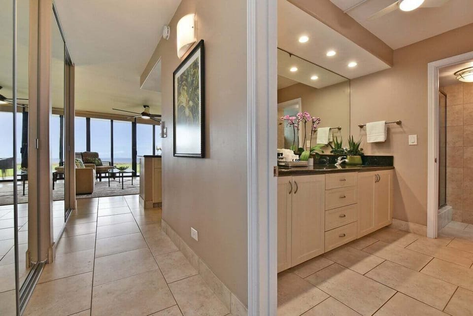 Elegant ensuite vanity featuring high-end stone tops and modern cabinetry.