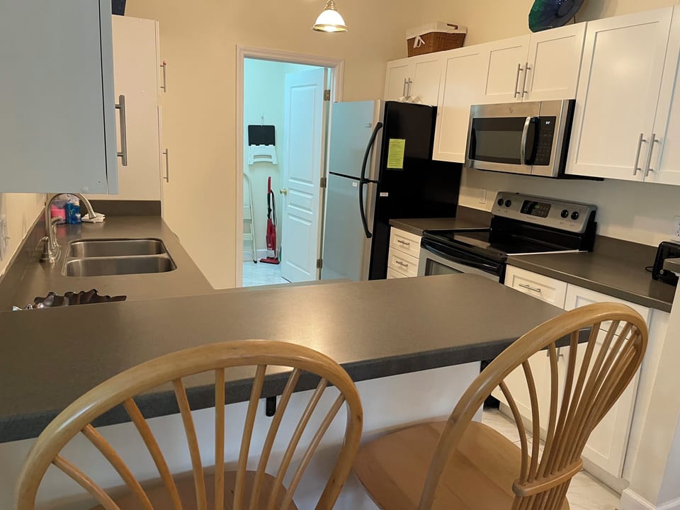 Kitchen with laundry room in background