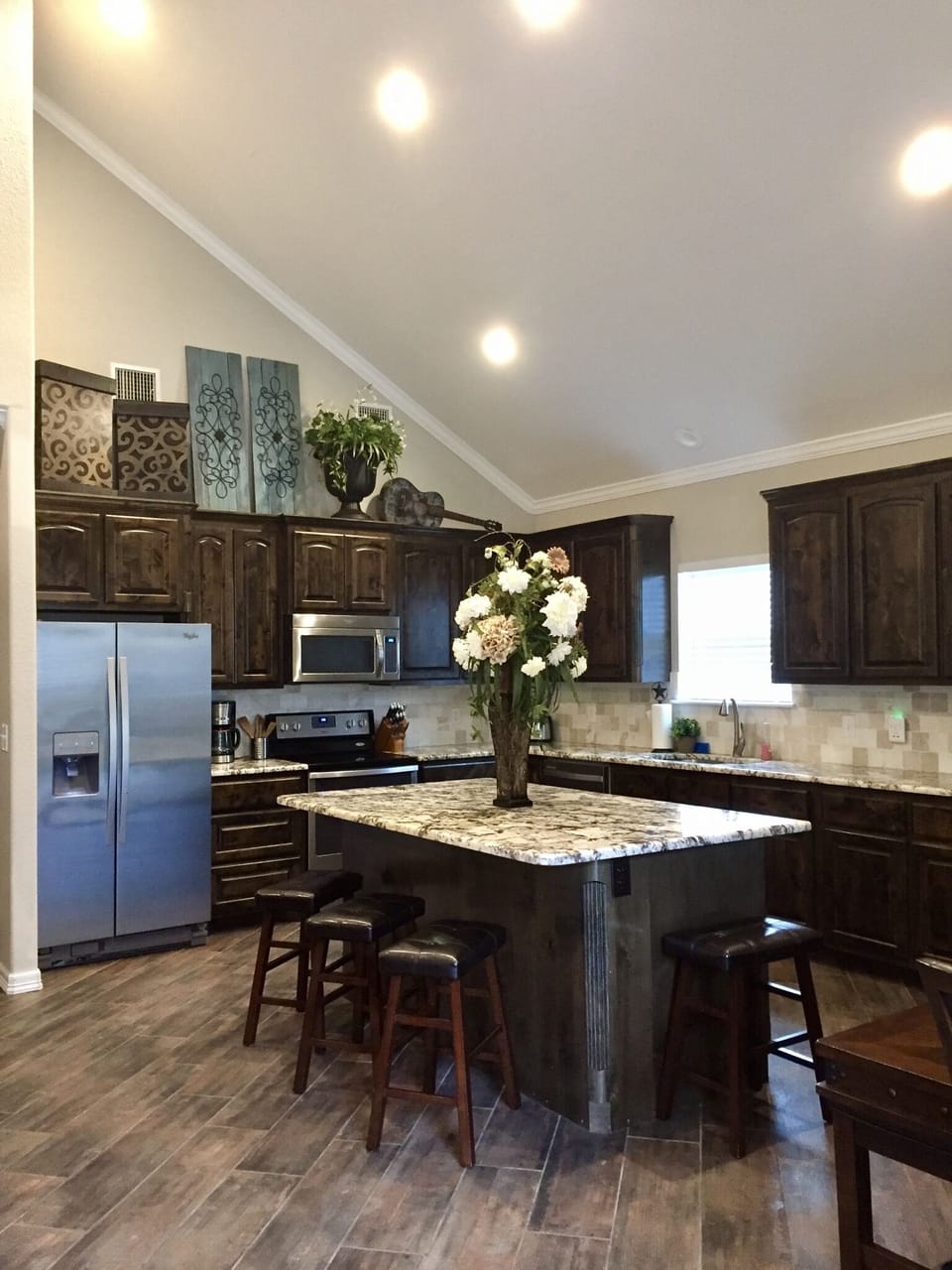 Kitchen includes gorgeous cabinetry and granite countertops  w/ oversized island