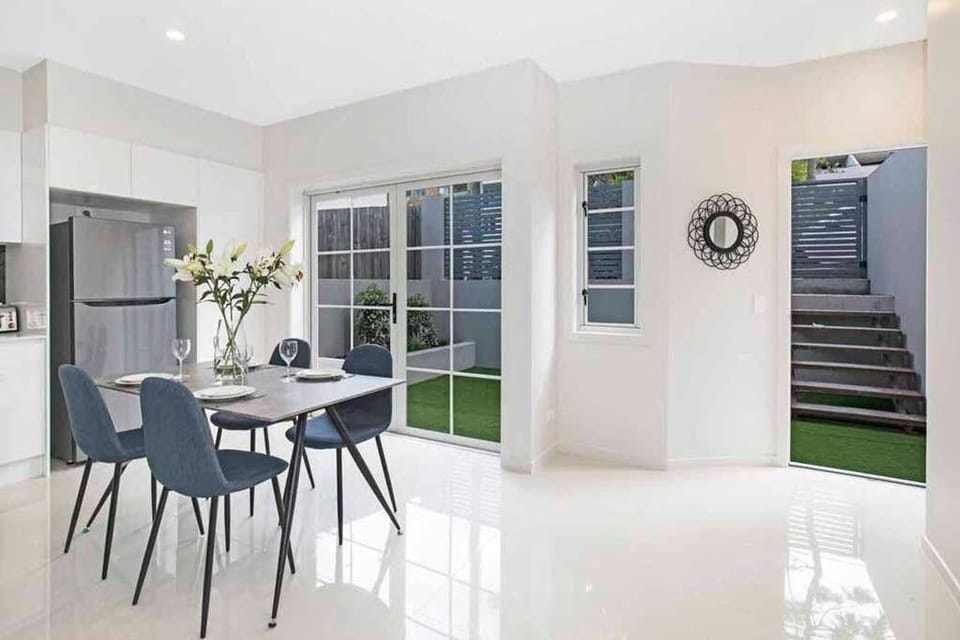 Indoor dining opens to the private courtyard for a brighter ground-floor feel.