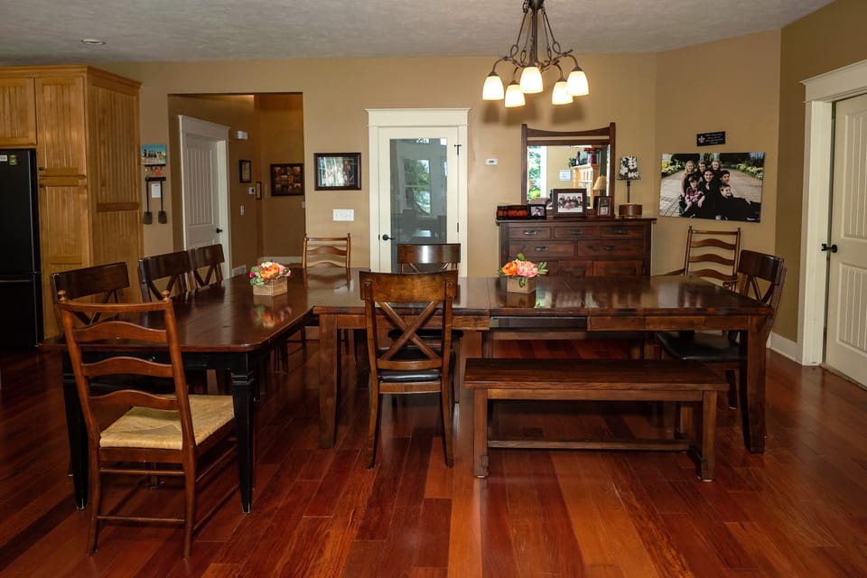 Dining room w two dining tables- sits whole family together for meals!