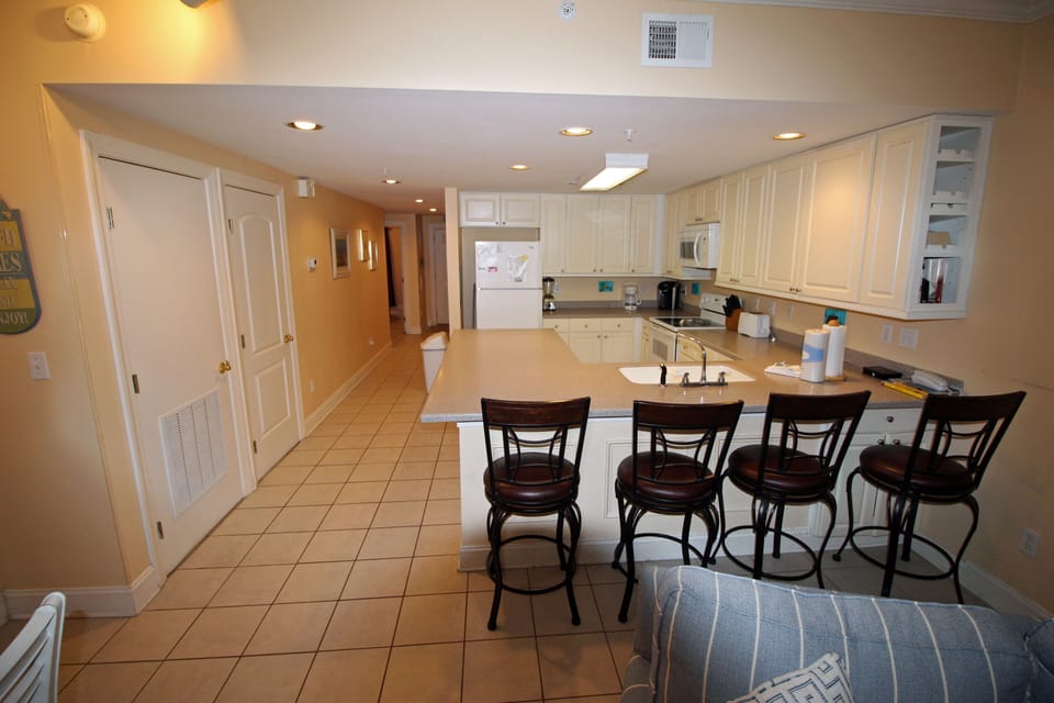 View of Kitchen from Living Room. There is a large pantry on the left.
