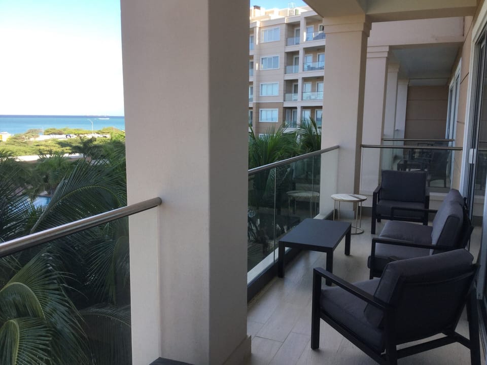 balcony off living room with a spectacular view of the ocean and sunsets