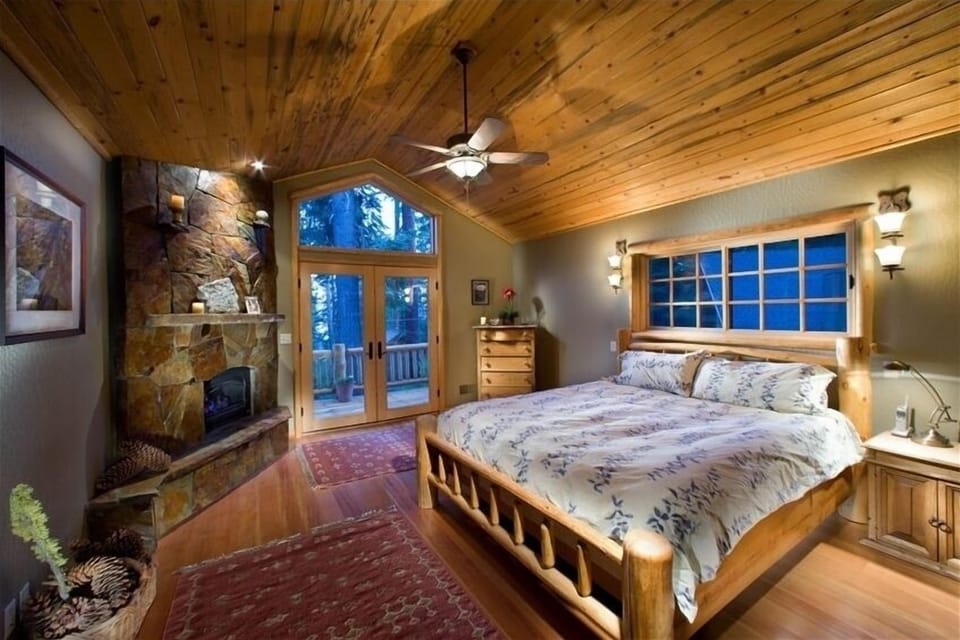 The Upstairs Master Bedroom, with a peek of Lake Tahoe. Hand-made Log Bed