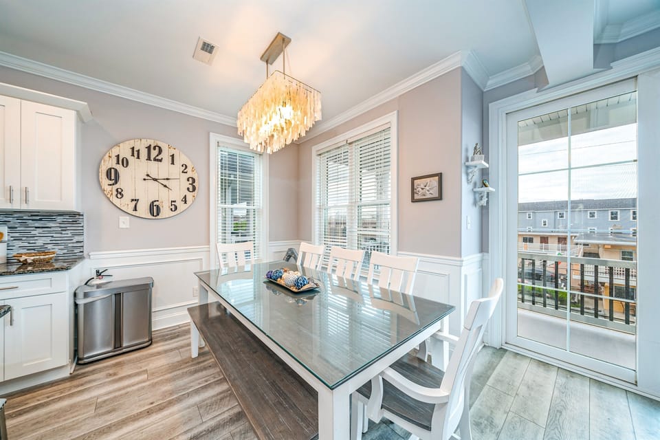 Bright dining area with seating for eight and balcony access