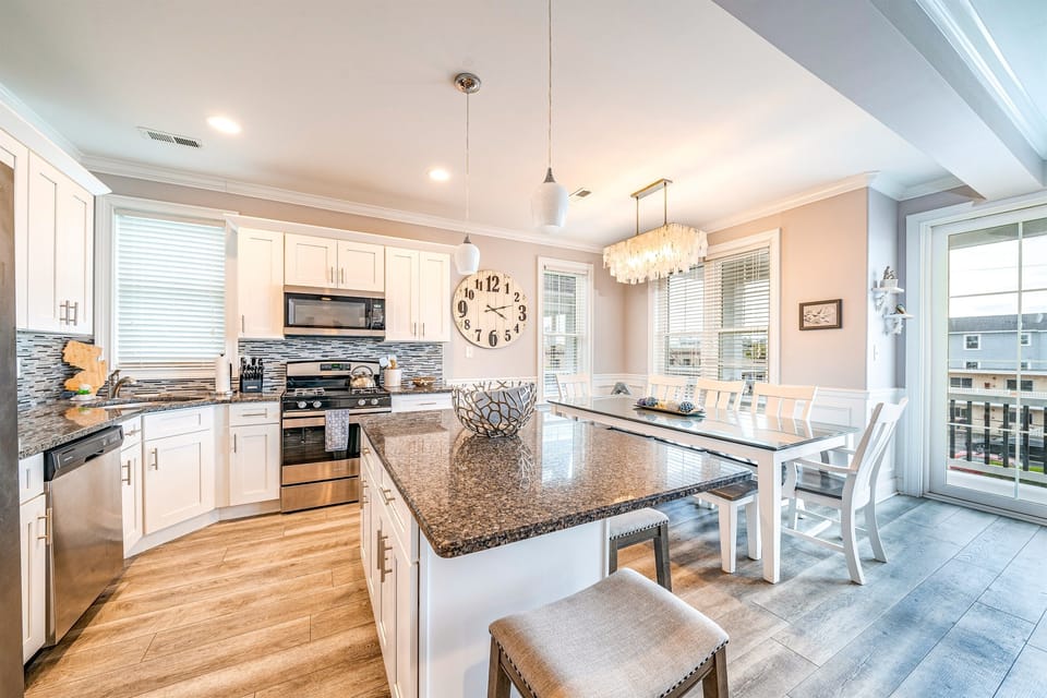 Stunning chef’s kitchen with granite island and dining area