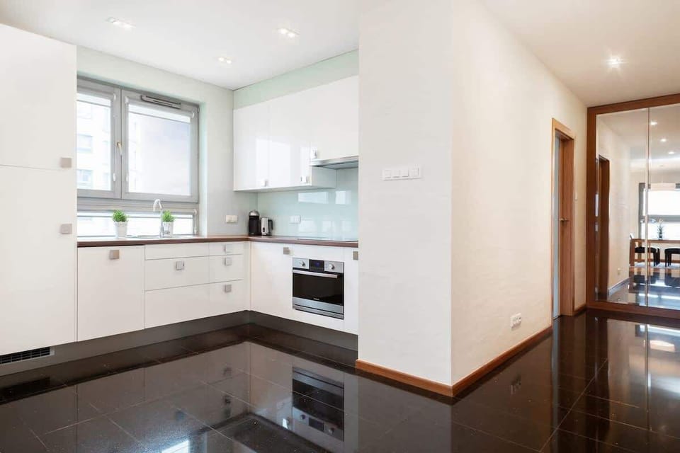 White furniture and high-quality appliances allow for home-cooked dinners.