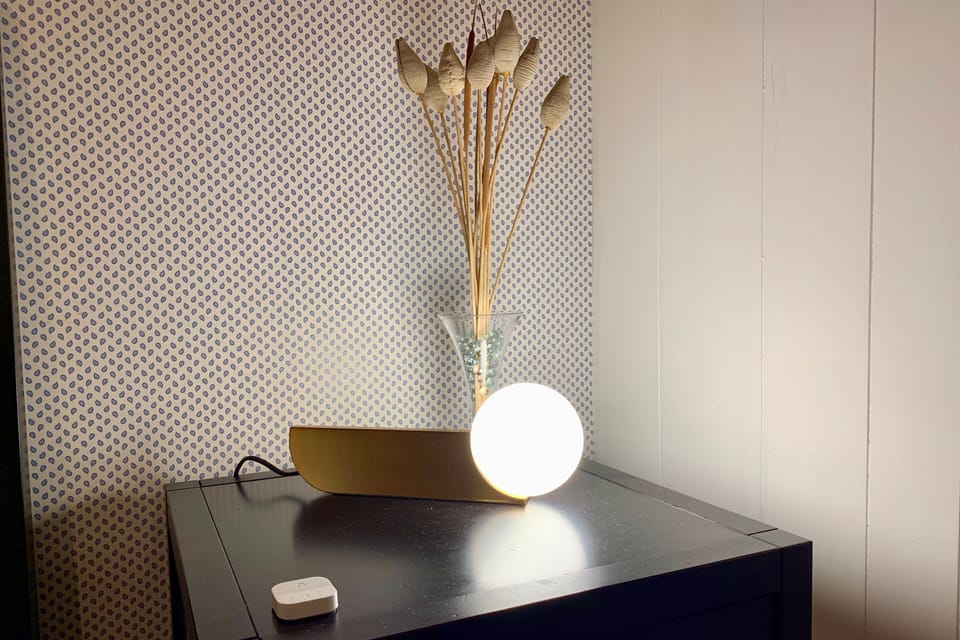 Guest bedroom nightstand with smart lighting.