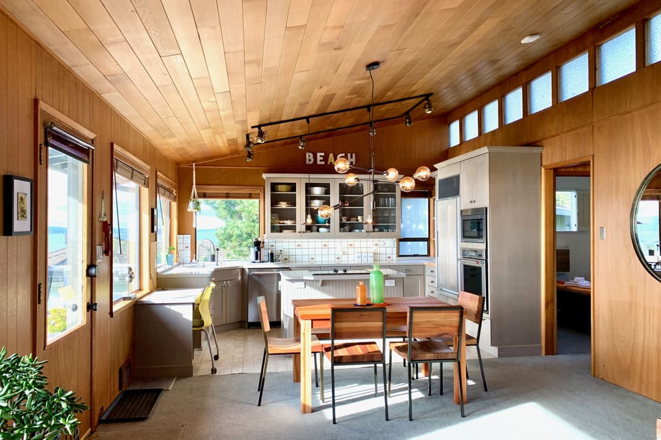Great room dining area has seating for 6 via 4 chairs and a bench.